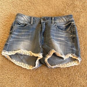 High waisted jean shorts with white lace embellishment. Juniors size 9.